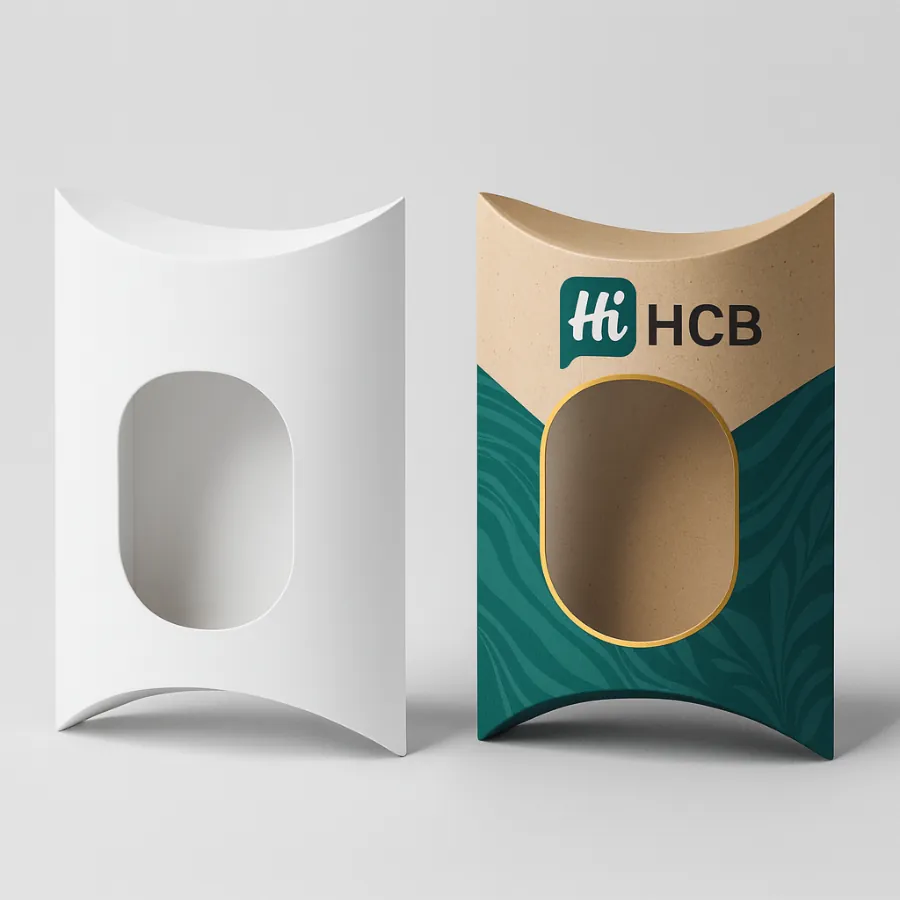 White pillow box with an oval die-cut next to a kraft paper box with green design and a clear window class=